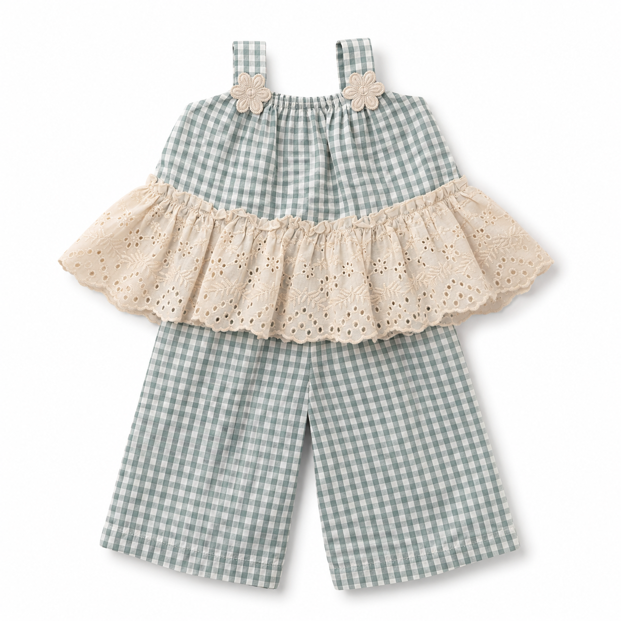 A baby girl's two-piece outfit featuring a sage green and white gingham romper with a cream eyelet ruffle overlay and matching cream flower appliques on the shoulder straps.